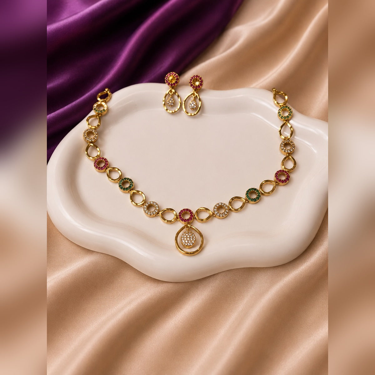 Gold-tone open teardrop-link necklace and earring set with coloured crystal rings