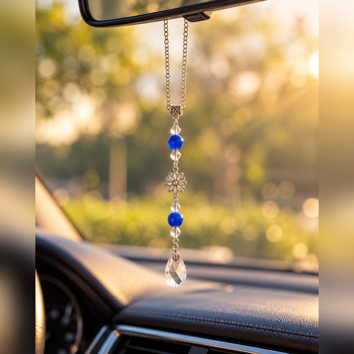 Royal blue crystal car charm with bright blue beads, silver flower charm and clear teardrop crystal, hanging from a rearview mirror