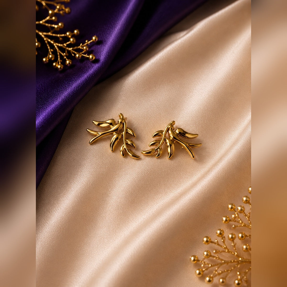 Gold bird on branch sculptural stud earrings