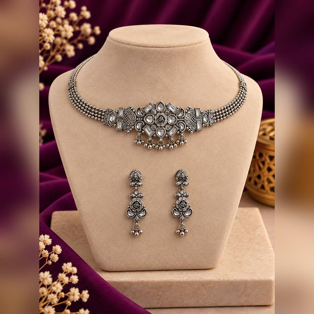 Antique silver filigree choker necklace and earring set on a display bust