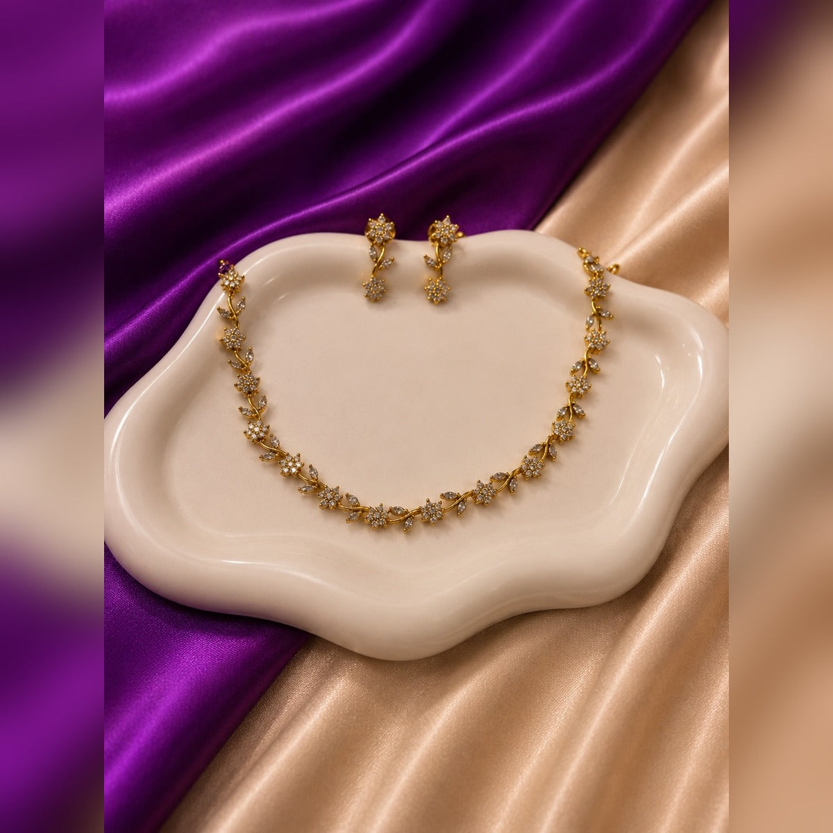 Gold necklace and earring set with crystal flower and marquise stations
