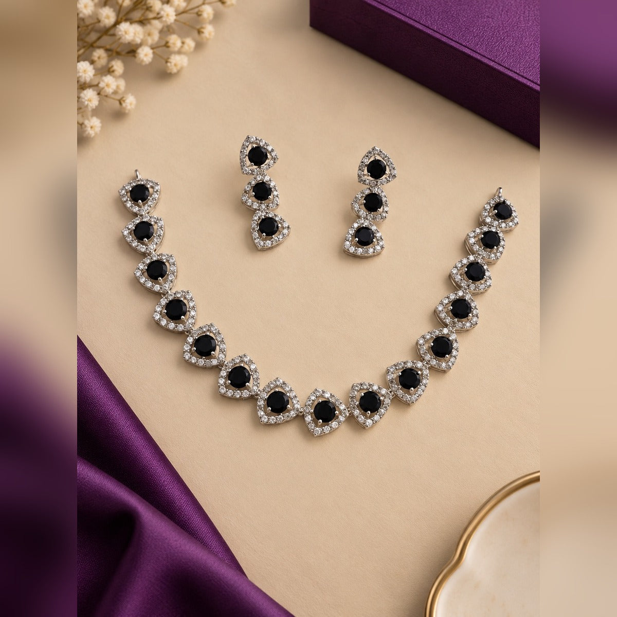 Silver-tone necklace and earring set with black round stones in crystal halos