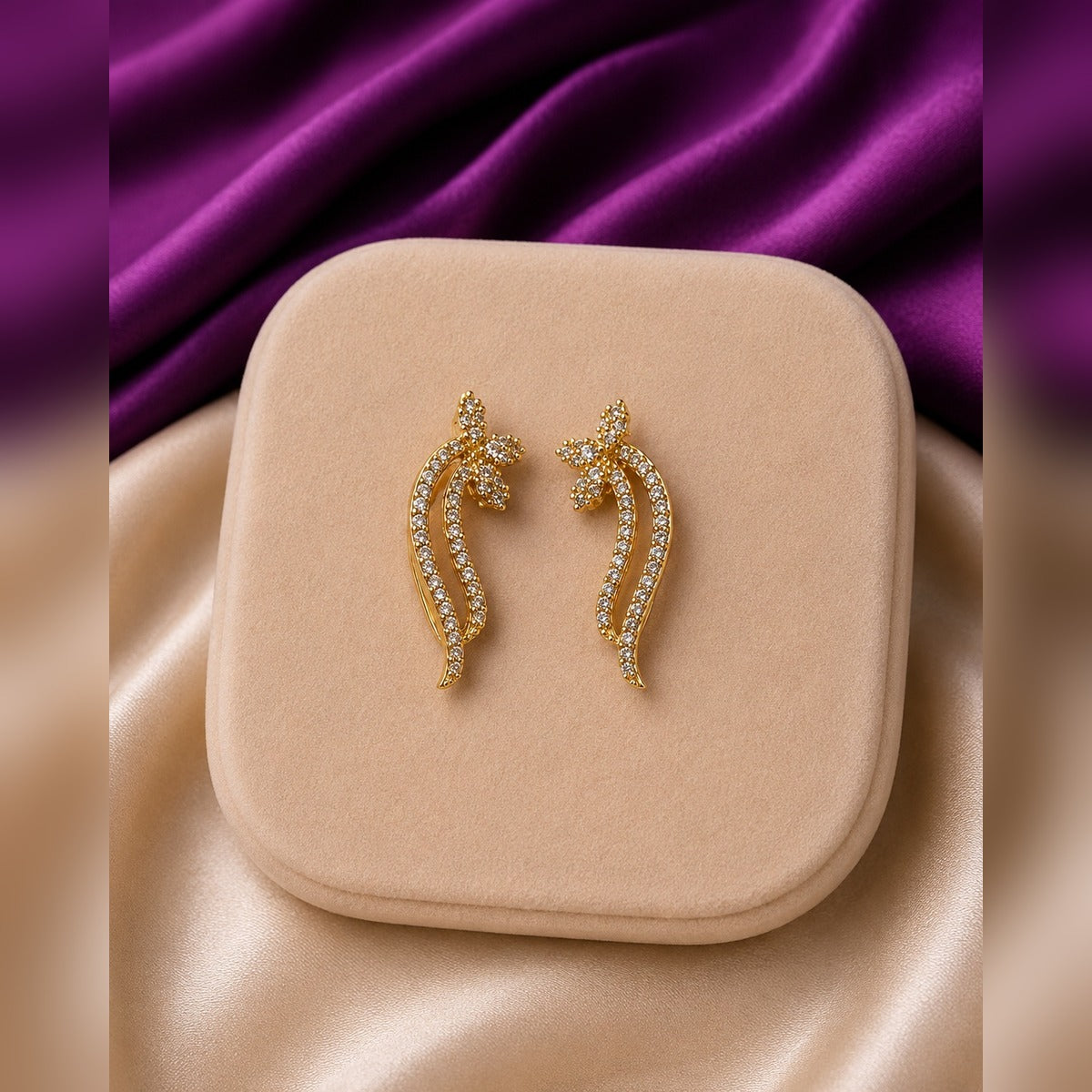 Gold curved crystal earrings with flower tops