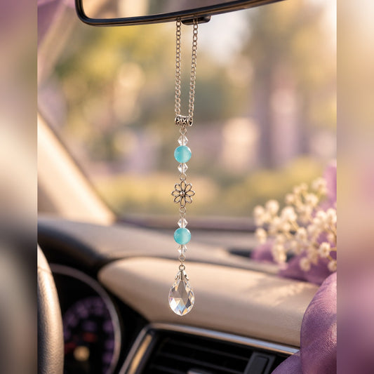 Aqua crystal car charm with blue beads, silver flower charm and clear teardrop crystal, hanging from a rearview mirror