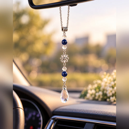 Navy blue crystal car charm with dark blue beads, silver flower charm and clear teardrop crystal, hanging from a rearview mirror