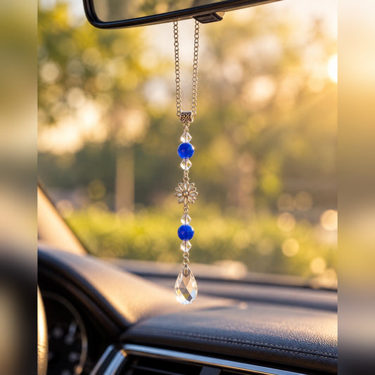 Royal blue crystal car charm with bright blue beads, silver flower charm and clear teardrop crystal, hanging from a rearview mirror