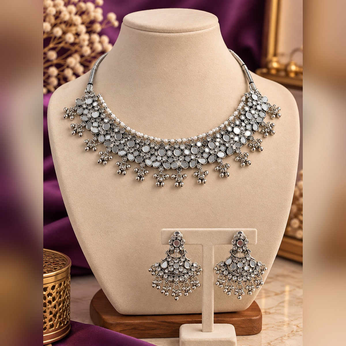 Mirrored silver choker necklace with mirror inlays, pearls and bead drops, plus matching jhumka earrings, on a display bust