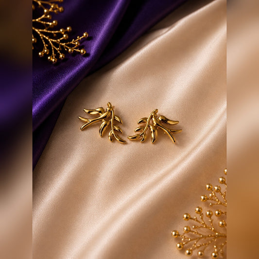 Gold bird on branch sculptural stud earrings