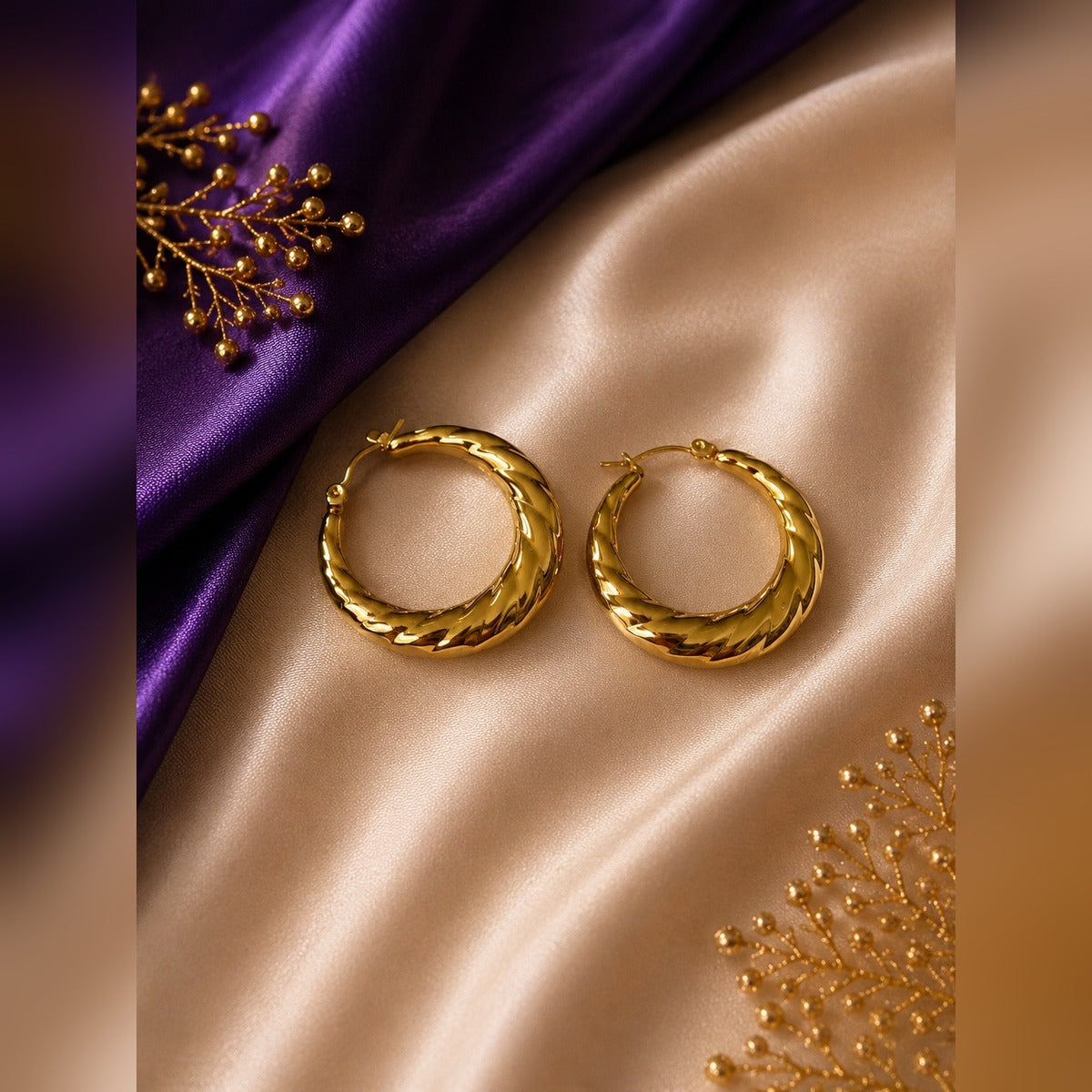 Gold chunky twisted hoop earrings with diagonal fluted twist grooves