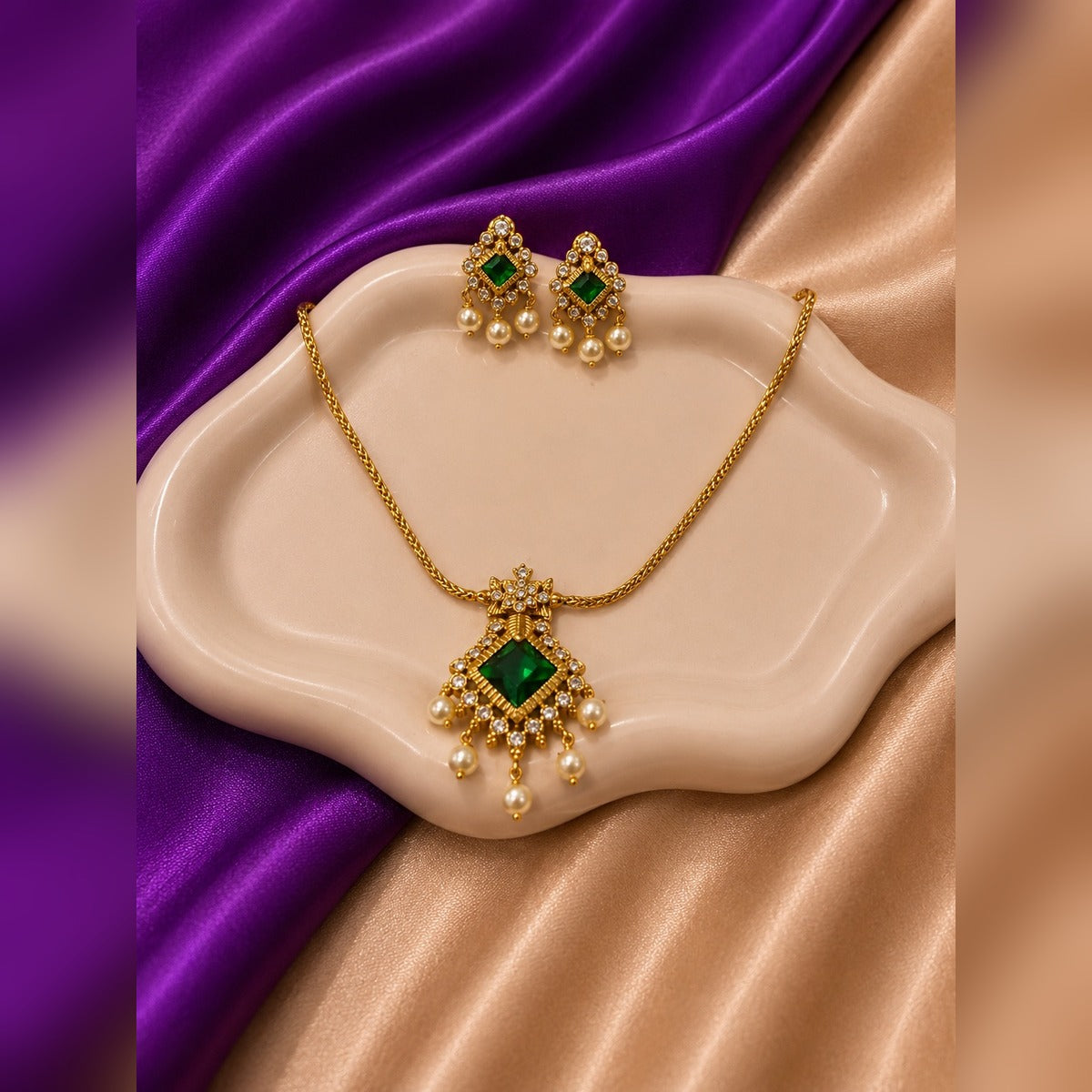 Gold necklace and earring set with large emerald diamond pendant and pearl drops
