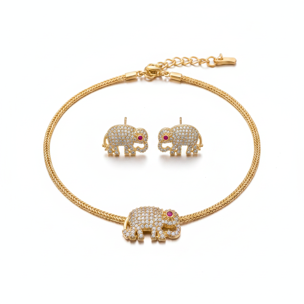 Gold elephant CZ pendant necklace and earring set with ruby eye on white background