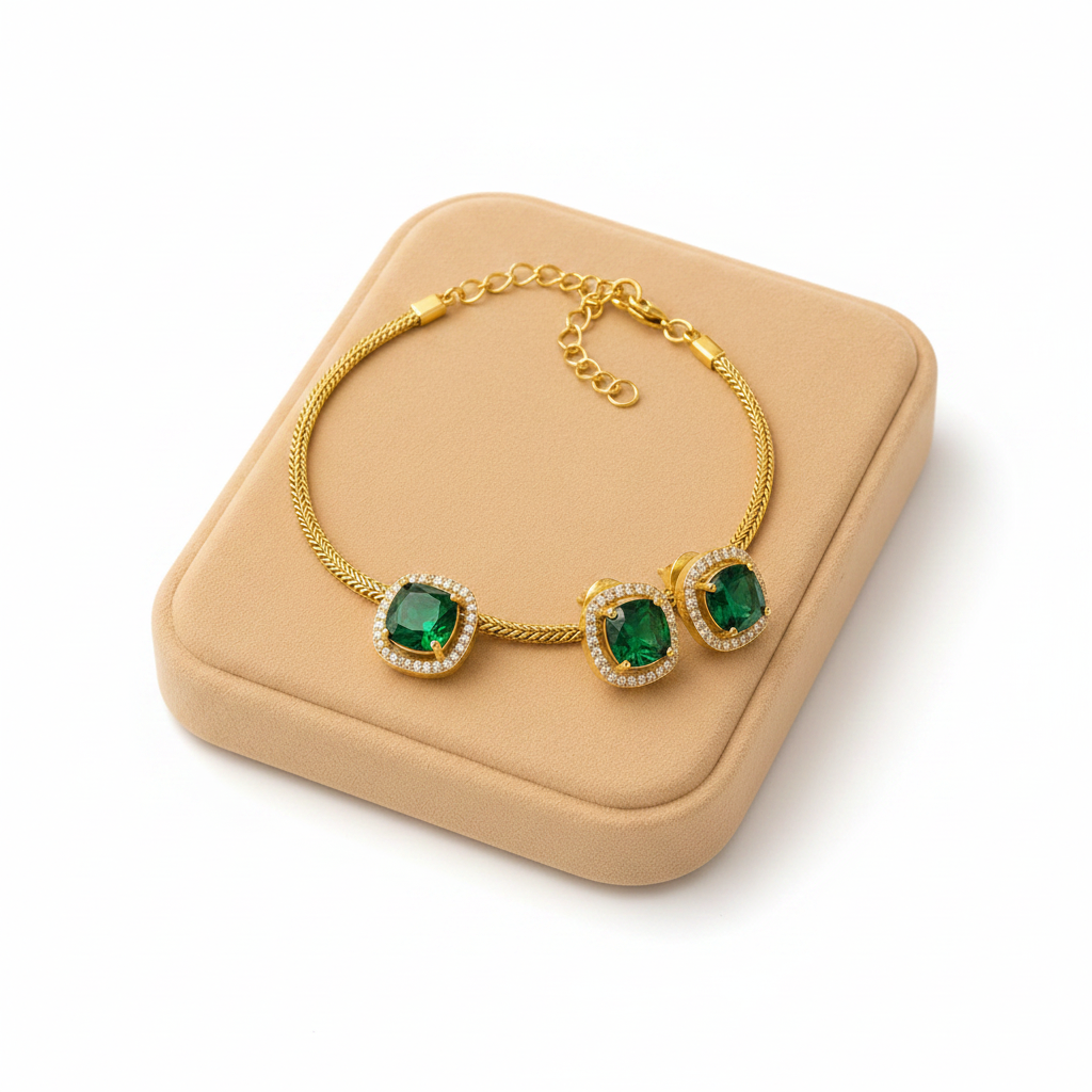 Gold cushion emerald halo solitaire necklace and earring set on white background