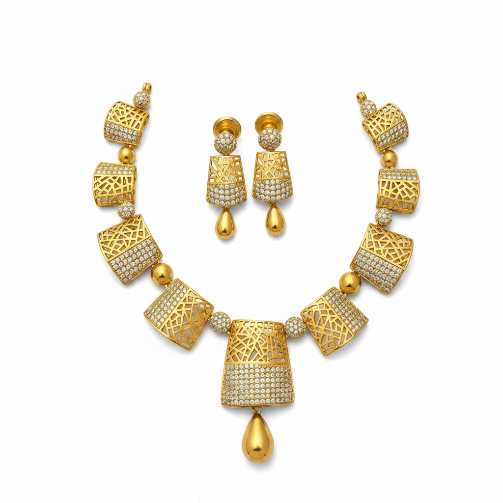 Gold geometric lattice necklace and earring set with CZ stones on white background