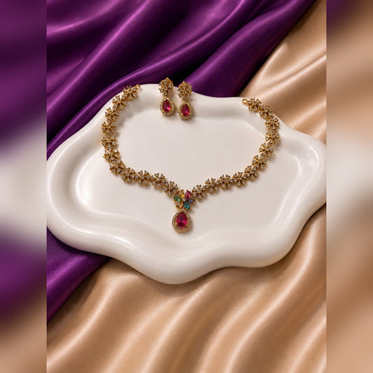 Gold crystal flower-link necklace with multicolour flower centre and ruby teardrop pendant