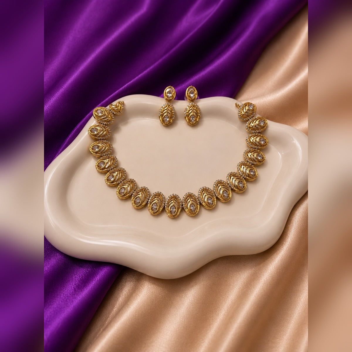 Gold necklace and earring set with oval filigree crystal stations and oval drop earrings