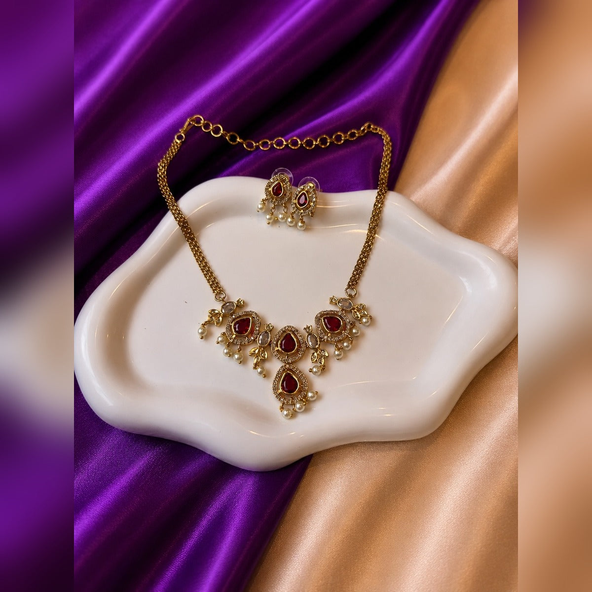 Gold mesh-chain necklace set with ruby teardrop stations, clear oval stones and pearl drops