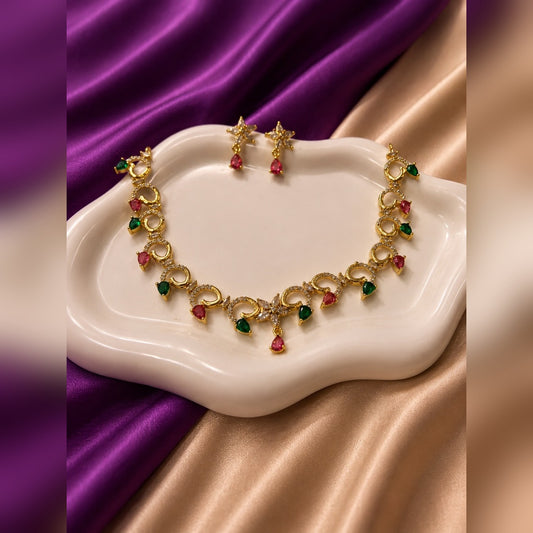 Gold swirl circle-link necklace with ruby and emerald teardrop drops and crystal flower centre