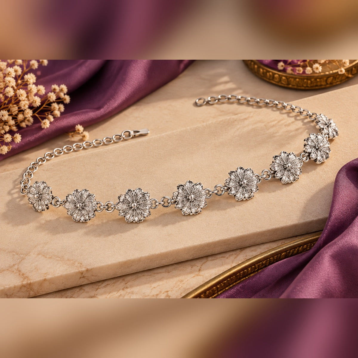 Silver floral waist chain with seven filigree flower stations on a fine chain, lobster clasp and extender